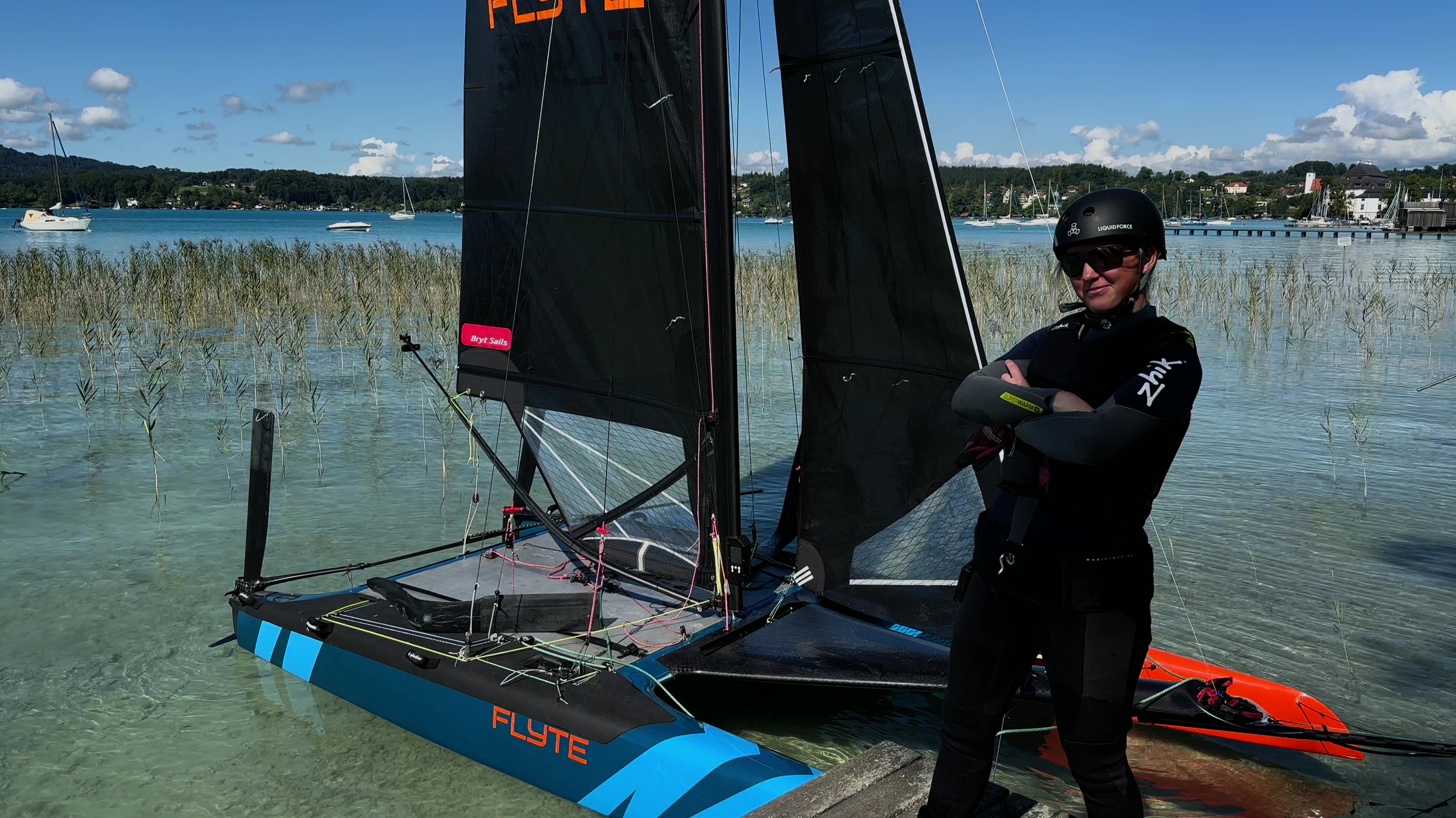 Caroline in SailGP pose in front of Flyte before takeoff